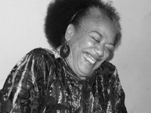 Black and white image of Jean Binta Breeze laughing